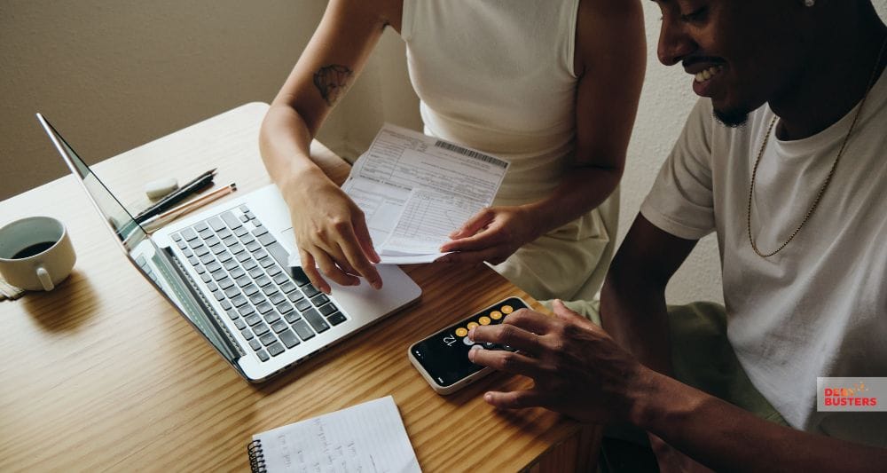 Couple reviewing credit report and calculator while discussing what is a good credit score Australia.