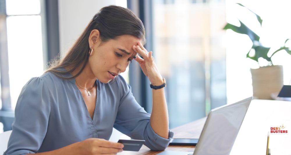 Worried woman checks card balance, wondering what is a good credit score Australia