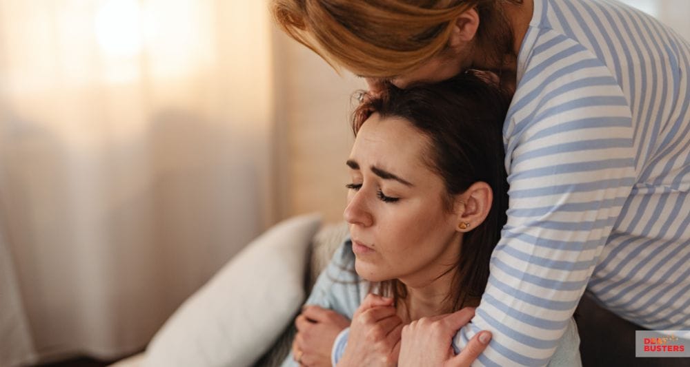 Stressed couple seeking emotional support while exploring charities that help with rent arrears.